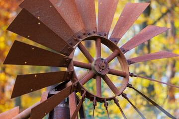Brown tin round pinwheel - wind indicator on the farm.