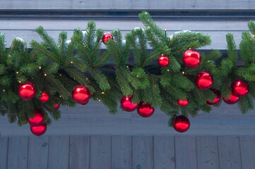 Beautiful colorful red Christmas balls on the background of green spruce branches