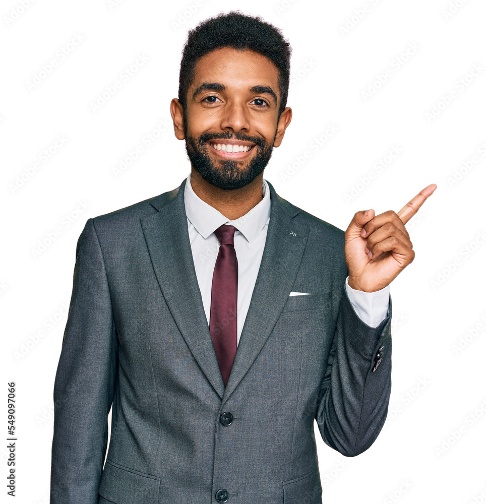 Canvas Prints Young african american man wearing business clothes with a big smile on face, pointing with hand and finger to the side looking at the camera.