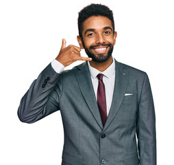 Young african american man wearing business clothes smiling doing phone gesture with hand and fingers like talking on the telephone. communicating concepts.