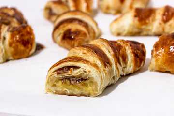 Baking in the form of a bagel with a filling inside of a whole banana and chocolate.