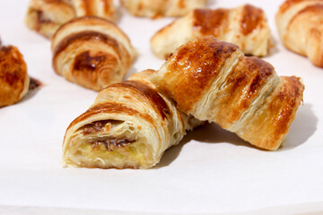 Baking in the form of a bagel with a filling inside of a whole banana and chocolate.