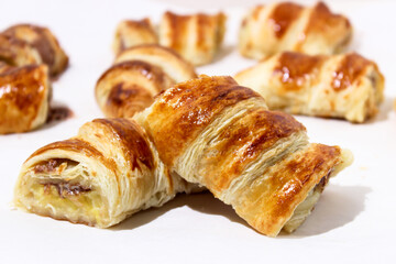 Baking in the form of a bagel with a filling inside of a whole banana and chocolate.