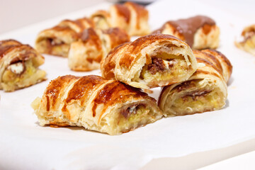 Baking in the form of a bagel with a filling inside of a whole banana and chocolate.