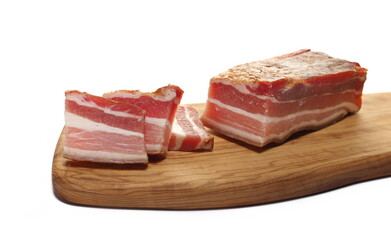 Dried and smoked bacon slice on chopping board isolated on white  