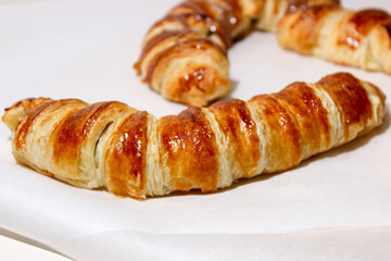 Baking in the form of a bagel with a filling inside of a whole banana and chocolate.