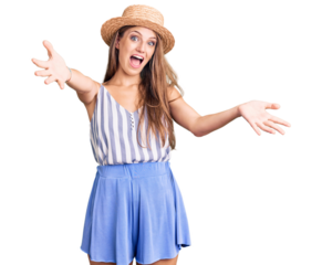 Young beautiful blonde woman wearing summer hat smiling cheerful offering hands giving assistance and acceptance.