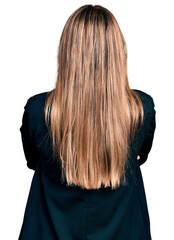 Naklejka premium Hispanic young woman wearing business jacket and glasses standing backwards looking away with crossed arms
