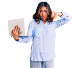 Young beautiful mixed race woman working using computer laptop with angry face, negative sign showing dislike with thumbs down, rejection concept