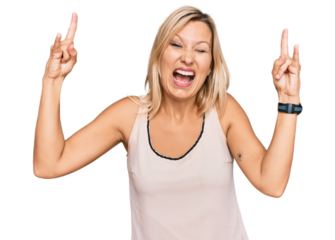 Middle age caucasian woman wearing casual clothes shouting with crazy expression doing rock symbol with hands up. music star. heavy music concept.