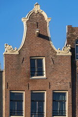 Close-up view details of old colorful building (XVI- XVIII centuries) with gable rooftop and hook along Korte Prinsengracht Canal in Amsterdam. Amsterdam, the Netherlands.