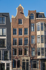 Close-up view details of old colorful building (XVI- XVIII centuries) with gable rooftop and hook along Korte Prinsengracht Canal in Amsterdam. Amsterdam, the Netherlands.