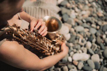 woman with sax on the beach 