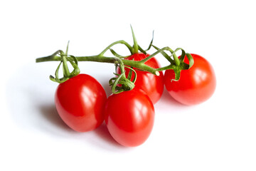 Cherry tomatoes cluster isolated on white. Fresh vegetable. Four red cherry tomatoes on branch