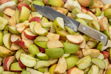 Fresh apples harvest background. Sliced red and yellow apple wedges for a healthy snacks or to make an apple pie, jam, cider or juice outdoors.