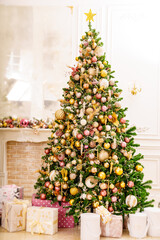 A large beautiful traditional Christmas tree with gifts in a classic interior.