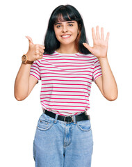 Young hispanic girl wearing casual clothes showing and pointing up with fingers number six while smiling confident and happy.