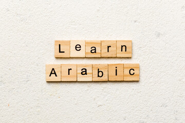 learn arabic word written on wood block. learn arabic text on table, concept