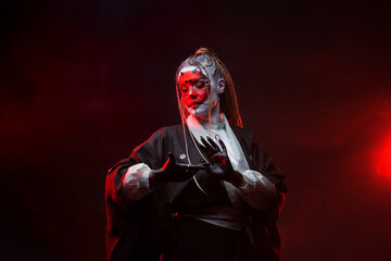A young woman in fantastic makeup and an Asian kimono, the image of a cyber geisha. Close-up...