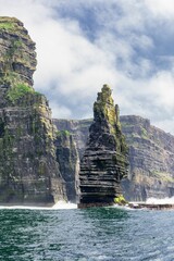 Vertical of the Cliffs of Moher under a cloudy blue sky