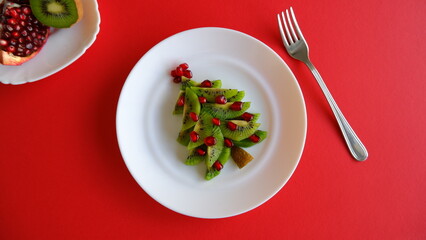 Funny edible Christmas and New Year tree idea for kids on red background