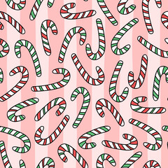 Vector seamless pattern with hand drawn candy canes on striped background. Cute design for Christmas wrapping paper and textile.