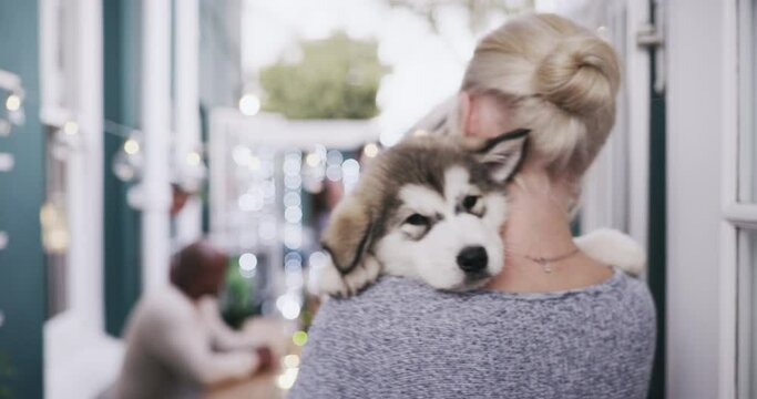 City, love and woman carrying dog in arms enjoying social event, party and celebration with pet outdoors. Adoption, animal care and girl holding adorable, cute and fluffy husky puppy over shoulder