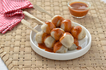 cilok is an abbreviation of aci dicolok or poked tapioca, since the tapioca balls are poked with skewers. Sundanese snack, served with peanut sauce.