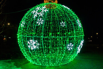 Large illuminated Christmas bauble on a city square