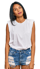 Obraz premium Young african american woman wearing casual clothes relaxed with serious expression on face. simple and natural looking at the camera.