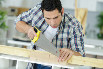 a man is cutting wood