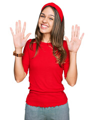 Young brunette woman wearing casual clothes showing and pointing up with fingers number nine while smiling confident and happy.