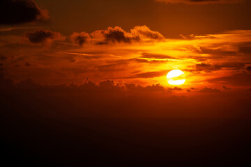 Dramatic colorful sunset sky with clouds over the sea