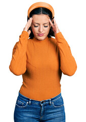 Young hispanic girl wearing casual white t shirt with hand on head for pain in head because stress. suffering migraine.