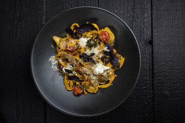 delicious pasta on a dark table in a restaurant

