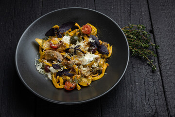 delicious pasta on a dark table in a restaurant
