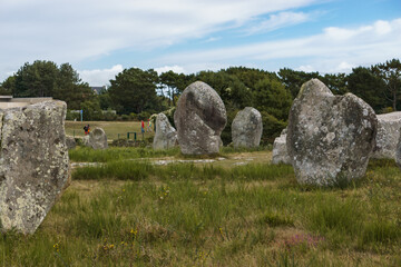Miles long megalithic stones alignment on green meadow in Carnac, Brittany, France