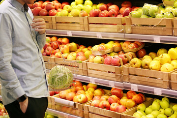 buying fruits(pears, apples,)  at the market