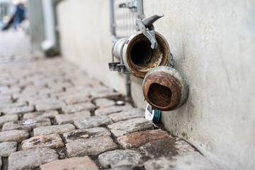 Disused pipe coupling formerly used to receive beer from tank truck.