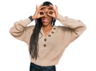 African american woman wearing casual clothes doing ok gesture like binoculars sticking tongue out, eyes looking through fingers. crazy expression.