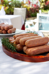 raw sausages, out door, white table, sunny day