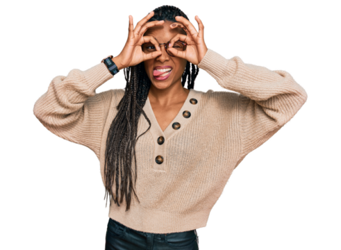 African american woman wearing casual clothes doing ok gesture like binoculars sticking tongue out, eyes looking through fingers. crazy expression.