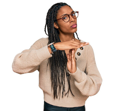 African american woman wearing casual clothes doing time out gesture with hands, frustrated and serious face