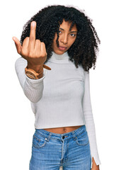 Young african american girl wearing casual clothes showing middle finger, impolite and rude fuck off expression