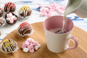 Cocoa bombs are black chocolate shells filled with cocoa powder and marshmallows that melt when hot...