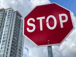 stop sign on blue sky background city 
