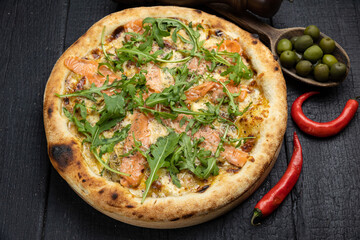 tasty pizza with cheese and vegetables on a wooden dark table

