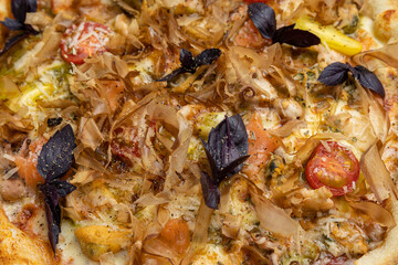 tasty pizza with cheese and vegetables on a wooden dark table
