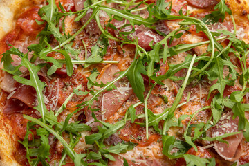 tasty pizza with cheese and vegetables on a wooden dark table
