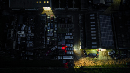 Aerial view of small industial estate at night with few units still open, West Sussex, UK